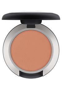 Blush compact met een ronde vorm, voorzien van een textuur van perzik-kleurige blush, ingekapseld in een zilveren rand met een zwarte bovenkant.