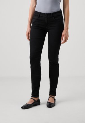 Black skinny jeans made of denim, featuring no visible distressing, slim fit, mid-rise waist, and traditional five-pocket design.