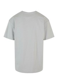 Light grey cotton t-shirt, short sleeves, round neckline, soft texture, relaxed fit, seamless back design, no graphics or embellishments.
