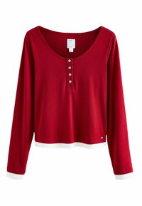 Red long-sleeve top with a scoop neckline and five button placket. Features contrast white cuffs and hem. Soft, lightweight fabric.