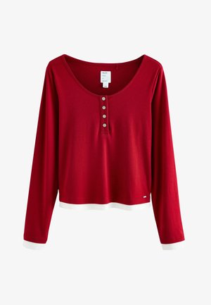 Rotes Langarmoberteil mit weitem Ausschnitt und fünf Knöpfen. Mit kontrastierenden weißen Bündchen und Saum. Aus weichem, leichtem Stoff.