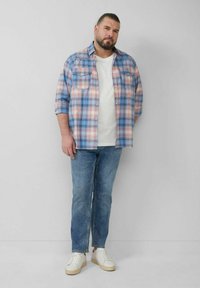 Blue and pink plaid button-up shirt, white crew neck t-shirt underneath, light blue jeans, and white sneakers with beige soles.
