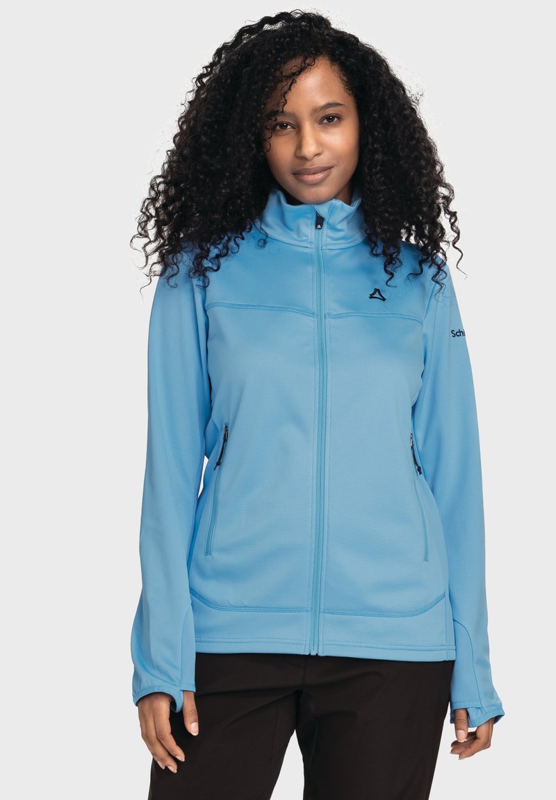 Blaue Reißverschlussjacke aus weichem Material mit strukturierter Oberfläche, ausgestattet mit zwei Reißverschlusstaschen und einem hohen Kragen.