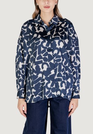 Blusa a maniche lunghe blu navy con un motivo astratto bianco, dotata di colletto e bottoni. Realizzata in tessuto leggero e morbido.