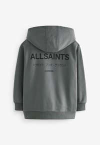 Felpa grigia scura con cappuccio ampio, polsini e orlo a costine, caratterizzata da dettagli testuali neri sul retro: "ALLSAINTS" e caratteri giapponesi.