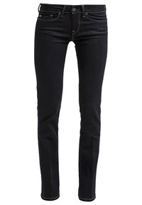 Jean noir slim avec poches avant et arrière, passants pour ceinture, et coutures jaunes visibles sur fond blanc.