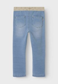 Light blue denim pants with a gold-patterned elastic waistband, featuring two back pockets and a straight leg design.