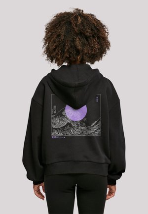 Black hoodie featuring a graphic print of waves and a purple circle on the back. Material appears soft with a loose, relaxed fit.