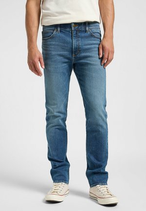 Blå denimjeans med rak passform, fem fickor och standardmidja. Har subtil blekning och kontrasterande sömmar. Avslappnad design.