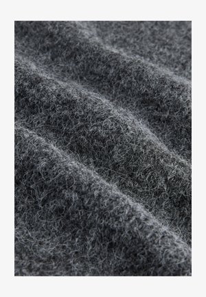 Textured gray fabric with a soft, fuzzy surface, featuring loose fibers and a slightly uneven weave pattern across the material.