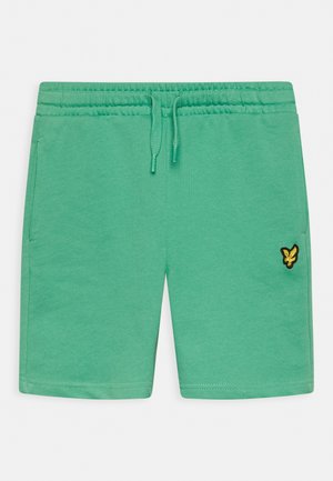 Pantaloni corti verdi casual con cintura elastica, coulisse, tasche laterali e un piccolo logo di un uccellino giallo sulla gamba destra.