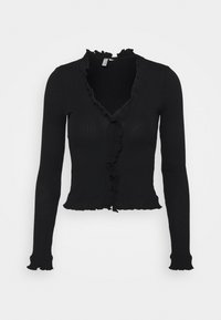 Svart ribbad cardigan med V-ringning, volangdetaljer längs halsringningen och fram, figurnära lång ärmar och en kortad nederkant.