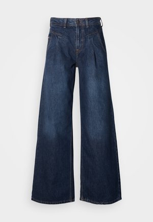 Wide-leg dark denim jeans with a high waist, featuring front pleats and subtle stitching details. Smooth texture, casual design.