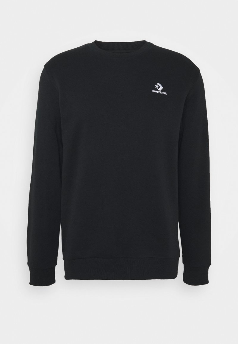 Sweatshirt noir en coton, avec un col rond, des manches longues et un petit logo Converse blanc sur la poitrine. Texture lisse.
