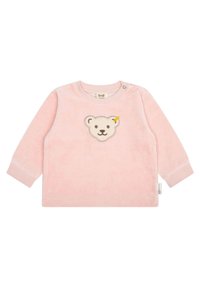 Camisa de manga larga rosa claro en tejido suave con un aplique de cara de oso y un acento amarillo, cuello redondo y broche en el hombro para facilitar el vestido.