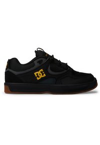 Black sneaker with mesh and suede materials, features a rubber sole, lace-up design, and a gold logo accent on the side.