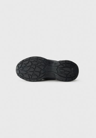 Black shoe sole with a textured pattern and deep treads for grip. Made of rubber, featuring a rounded shape and symmetrical design.