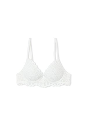Soutien-gorge en dentelle blanche avec bords festonnés et fines bretelles réglables, présenté sur un fond blanc uni.