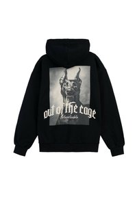 Czarna bluza z kapturem z dużą grafiką głowy psa, z napisem "poza klatką" w białym, kursywą, prezentująca luźny krój i miękką teksturę.
