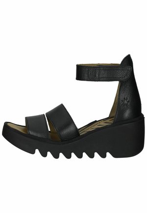 Black leather wedge sandals with three wide straps, an adjustable ankle strap, and a chunky, zigzag-patterned sole.