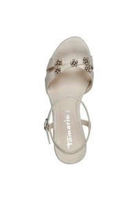 Μπεζ δερμάτινη σαγιονάρα με υφή, με σχέδιο λωρίδων που διασταυρώνονται, διακοσμημένη με μικρές ανθοστολίξεις και λωρίδα στον αστράγαλο.