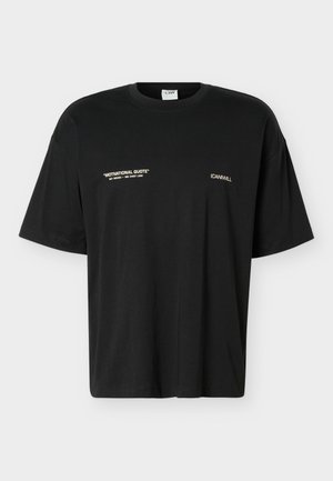 Tricou negru cu mânecă scurtă și guler rotund, text „MOTIVATIONAL QUOTE NOT NEEDED – SEE CHEST LOGO” pe partea stângă a pieptului și „ICANIWILL” pe partea dreaptă.