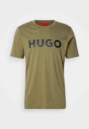 Olive green cotton t-shirt featuring a round neck and bold black "HUGO" logo across the chest, short sleeves, and a smooth texture.