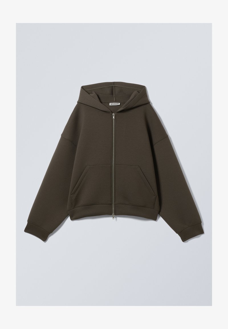 Dunkelgrüner Reißverschluss-Hoodie mit Kapuze, zwei vorderen Taschen und weiten Ärmeln. Hergestellt aus weich gewebtem Stoff mit lockerer Passform.