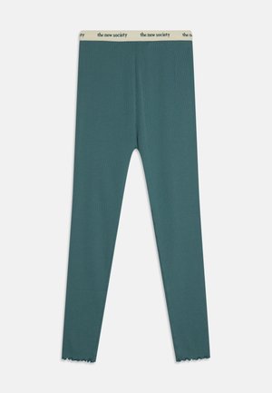 Leggings em verde-água feitos de tecido canelado, com uma cintura elástica bege que apresenta o logótipo "the new society". Detalhe de bainha em formato de onda nos tornozelos.