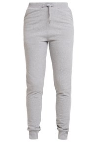 Ljust grå sweatpants i en bomullsblandning. Har en elastisk midja med dragsko, smalnande ben och ribbade muddars. Inga fickor synliga.