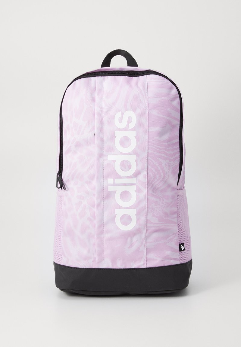 Pink backpack with a textured pattern, featuring a large white "adidas" logo, black base, and a top carry handle. Zippered compartment visible.