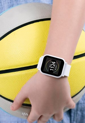 Orologio intelligente bianco con quadrante quadrato che mostra l'ora e la data, indossato al polso, sopra un pallone da basket giallo con superficie testurizzata.