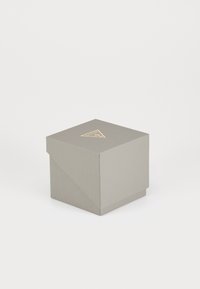 Gray cardboard box with a textured finish, square shape, featuring a triangular logo in gold on the lid. Closed style without visible contents.