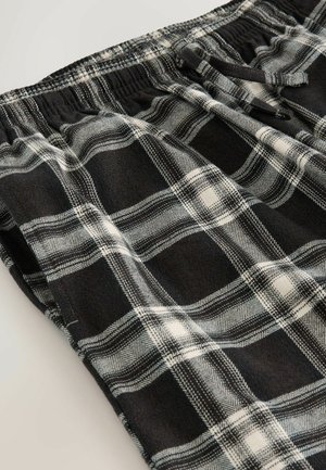 Czarno-białe szorty loungewear w kratę z miękkiego materiału, z elastycznym paskiem w talii i kontrastującymi wzorami w kratę z eleganckimi akcentami.