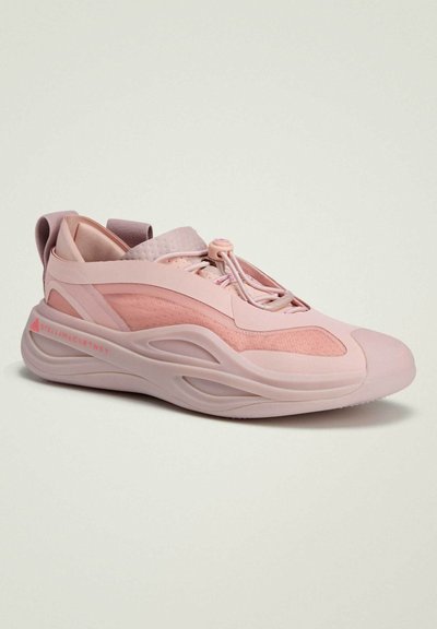 Light pink sneaker with a textured fabric upper and smooth rubber sole. Features elastic laces and a cushioned back for support.