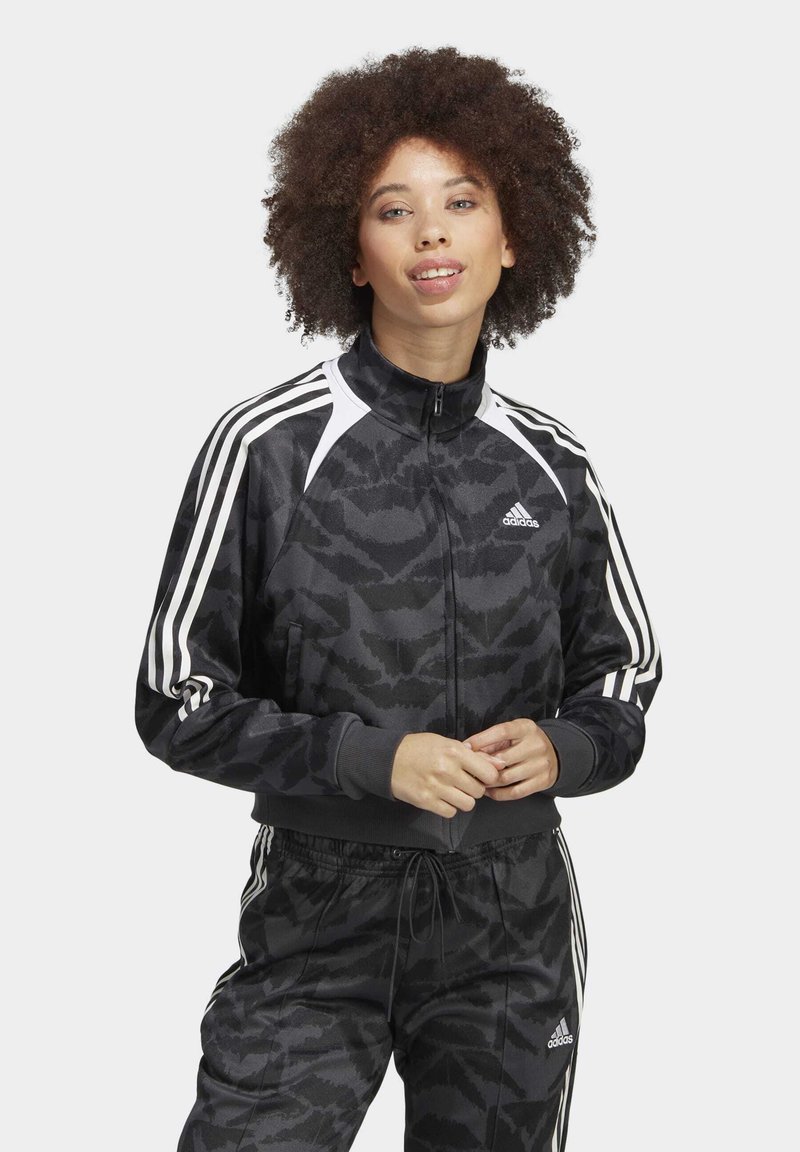 Black and gray athletic jacket with a textured camo pattern, white shoulder accents, full zipper, and classic three-stripe design.
