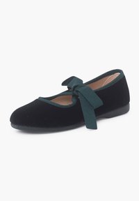Schwarze Samt-Ballettschuhe mit runder Zehenpartie, grüner Schleife vorne und flacher Gummisohle. Glatte Textur und minimalistisches Design.