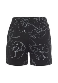 Zwarte shorts met witte bloemenontwerpen. Voorzien van een elastische tailleband. Gemaakt van stof met een gladde textuur.