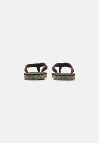 Dark brown flip-flops with textured straps and a multicolored patterned footbed. Thin design with a flat sole, suitable for casual wear.