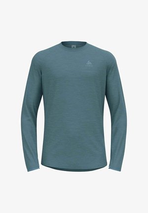 Long-sleeve active shirt in muted teal, made of textured fabric. Features a round neckline and subtle logo on the front.