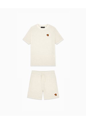 Matching cream short-sleeve T-shirt and drawstring shorts with small red and yellow heart patches, laid flat on a white background.
