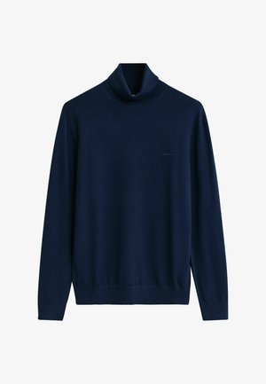 Suéter de cuello alto en color marino, confeccionado con tejido suave, que presenta mangas largas, una silueta ajustada y puños y dobladillo acanalados. Detalle sutil del logo.