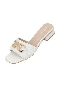 White slip-on sandal with textured woven upper and gold two-chain accent. Square toe, low block heel with tan and white outsole.