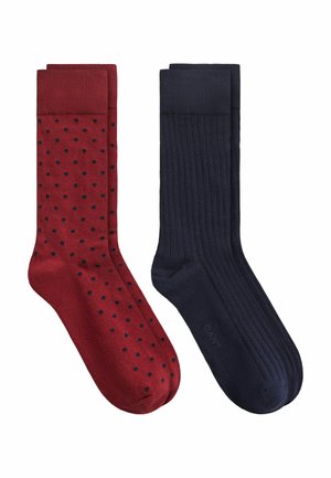 Deux paires de chaussettes mi-mollet, une bordeaux avec petits pois noirs, une bleu marine foncé unie avec texture côtelée.