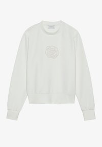 Sudadera blanca con cuello redondo, puños acanalados y un diseño floral texturizado en la parte delantera. Fabricada en tejido suave con un corte holgado.