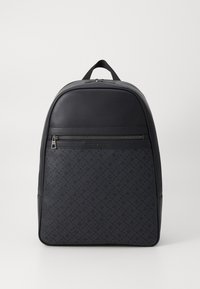 Black backpack with a smooth top and textured front, featuring a zippered pocket and subtle logo detail. Durable material and structured design.