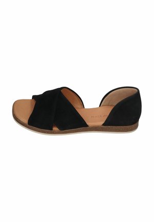 Black flat sandal with open toe, wide crisscross straps, and cushioned tan insole on a light brown sole.