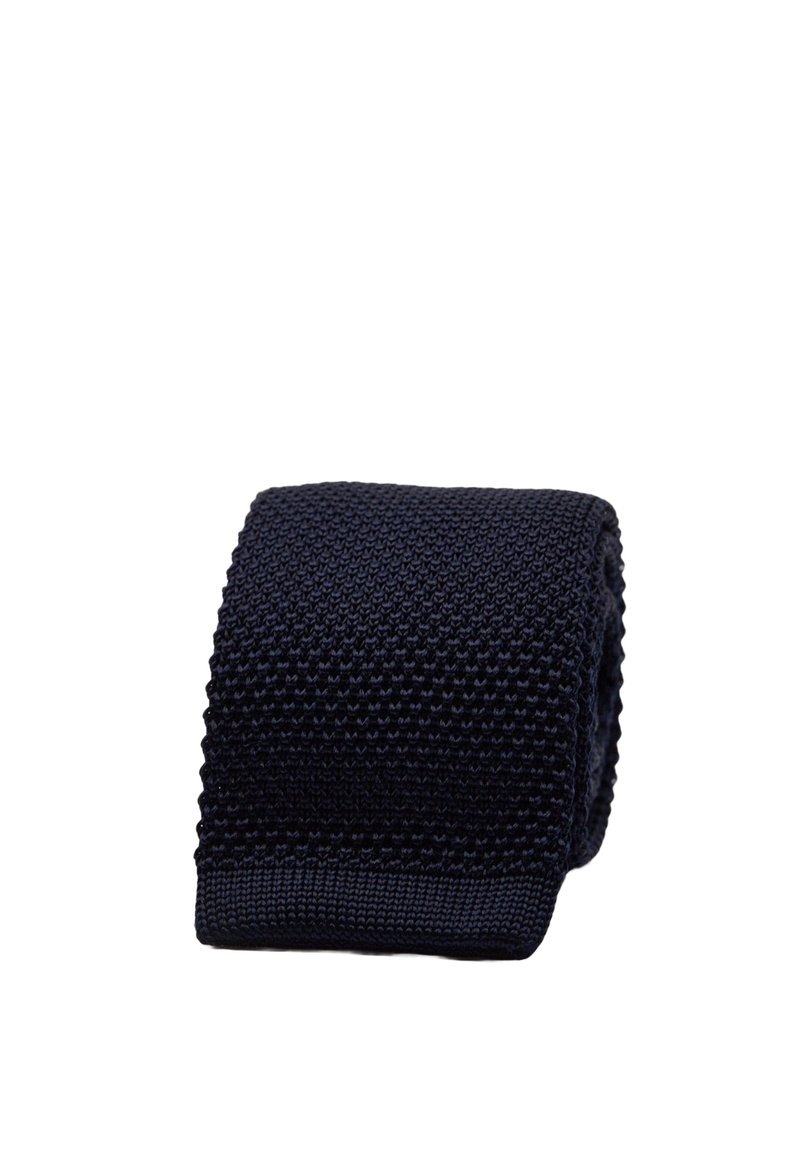 Marinblå stickad slips med ett strukturerat mönster och platt ände. Materialet verkar mjukt med en blandning av upphöjda maskor. Mäter cirka 6,5 centimeter i bredd.