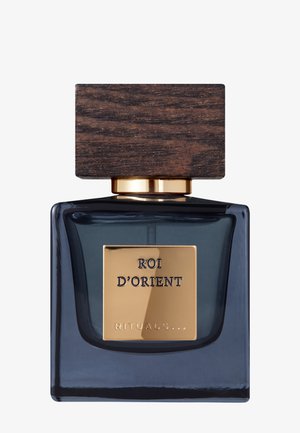 Glasparfümflasche mit einem dunklen Marineblau, quadratischer Form, goldfarbenem Etikett mit der Aufschrift "ROI D'ORIENT", gekrönt mit einem strukturierten Holzverschluss.