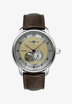 Zeppelin Automatikuhr mit einem silbernen und goldenen strukturierten Zifferblatt, braunem Lederarmband, Skelettfunktion bei 6 Uhr und blauen Akzenten auf den Zeigern.